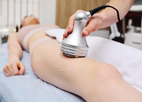 masseur performs cavitation to a young woman